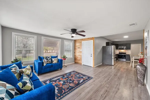 a living room with furniture and a large window