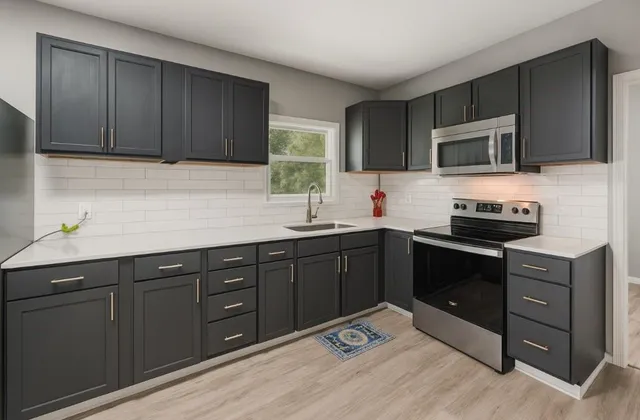 a kitchen with stainless steel appliances granite countertop wooden cabinets a stove top oven a sink and dishwasher