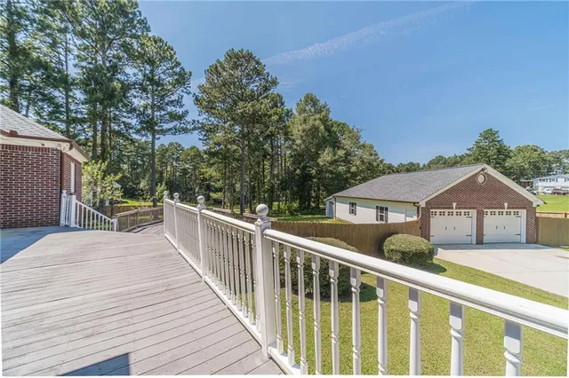 a kitchen with stainless steel appliances granite countertop a sink a stove top oven a counter space and cabinets