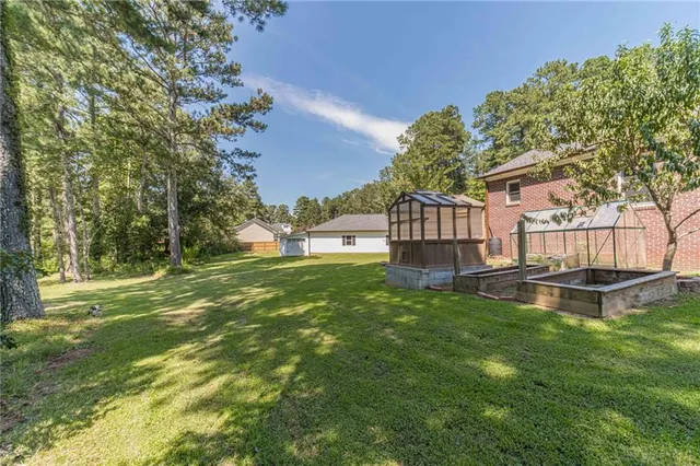 a kitchen with stainless steel appliances granite countertop a sink a stove top oven a counter space and cabinets