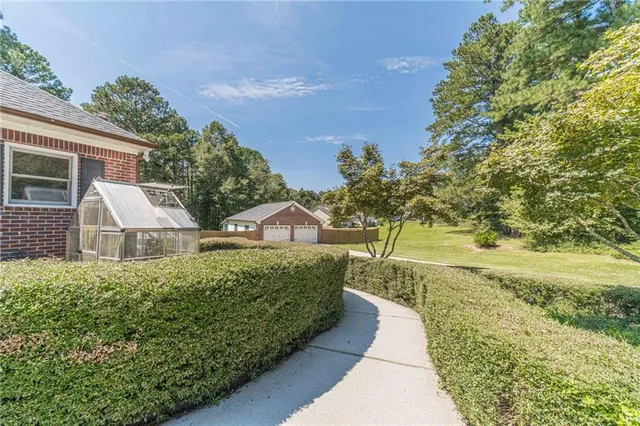 a front view of a house with a garden