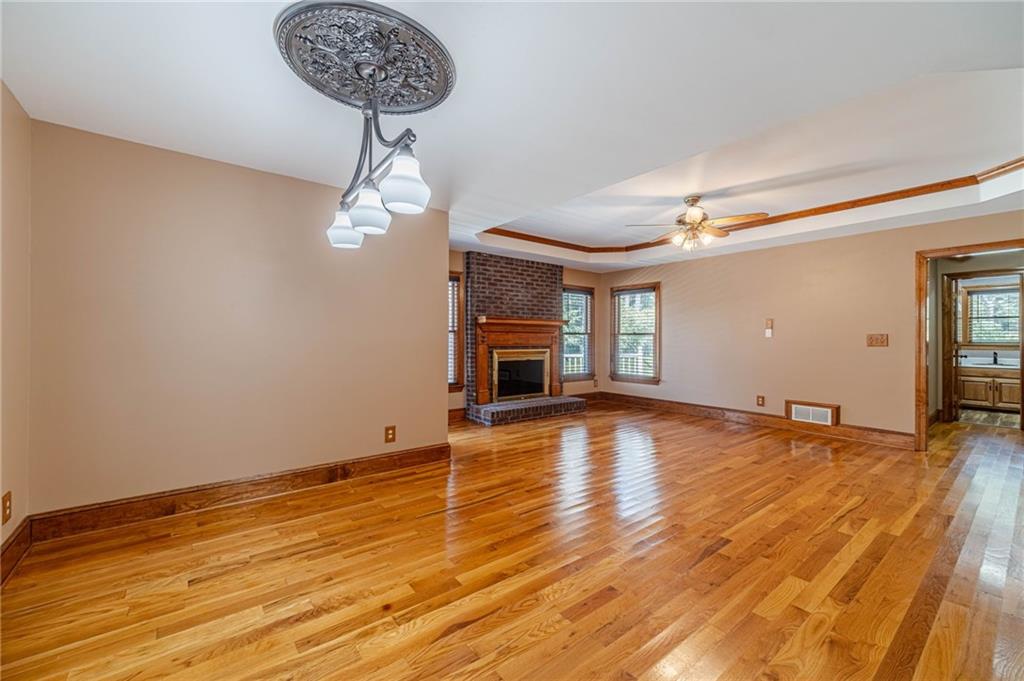 2705 Luke Edwards Road Dacula, GA 30019 - Photo 36 of 74 a view of empty room with wooden floor and fireplace