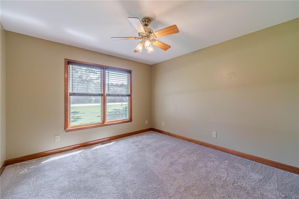 2705 Luke Edwards Road Dacula, GA 30019 - Photo 51 of 74 an empty room with a window and a ceiling fan