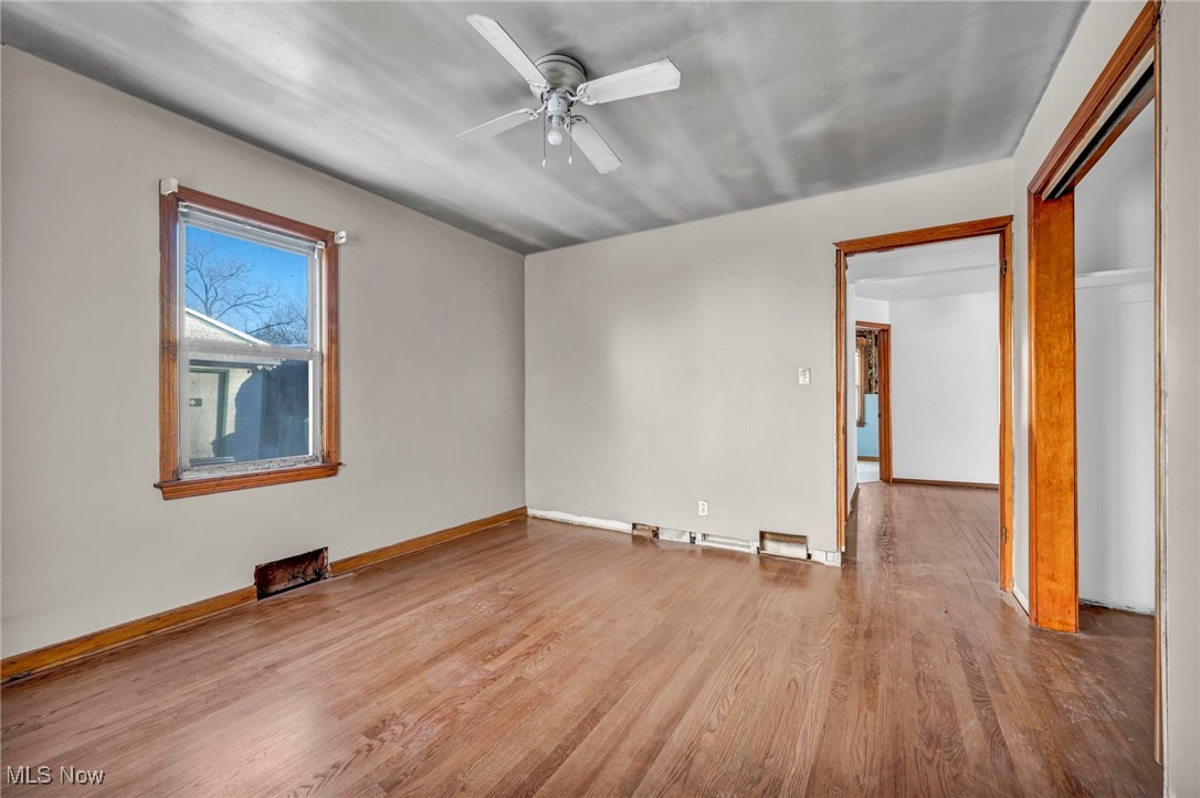 14750 Schreiber Road Maple Heights, OH 44137 - Photo 17 of 44 Empty room with wood finished floors and a ceiling fan
