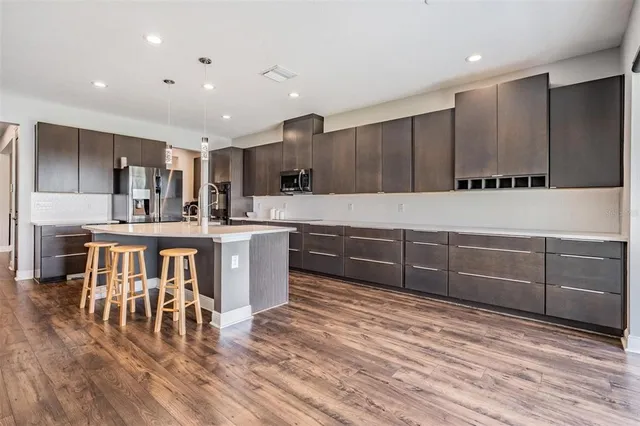 a kitchen with stainless steel appliances a refrigerator and a stove top oven