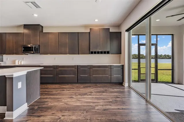 a living room with a large window and a sink