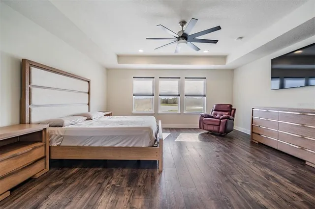 a bedroom with furniture a flat screen tv and a bed