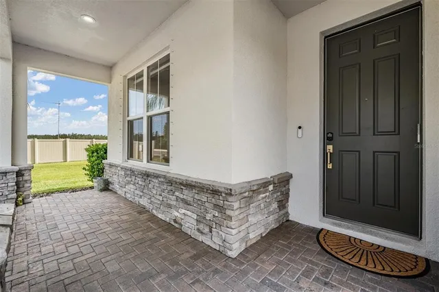 a living room with a couch and a chandelier