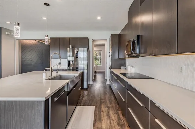 a large kitchen with a large counter top appliances and cabinets