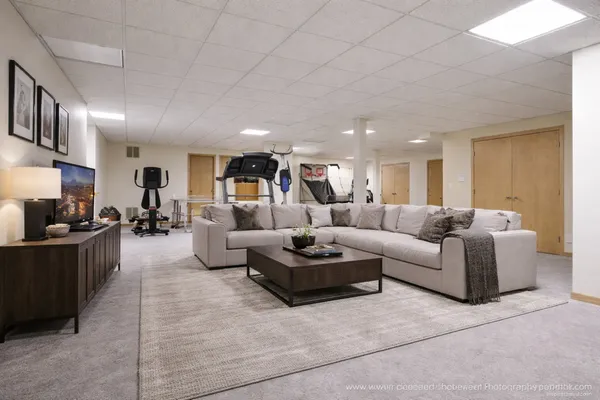 a living room with furniture and a wooden floor