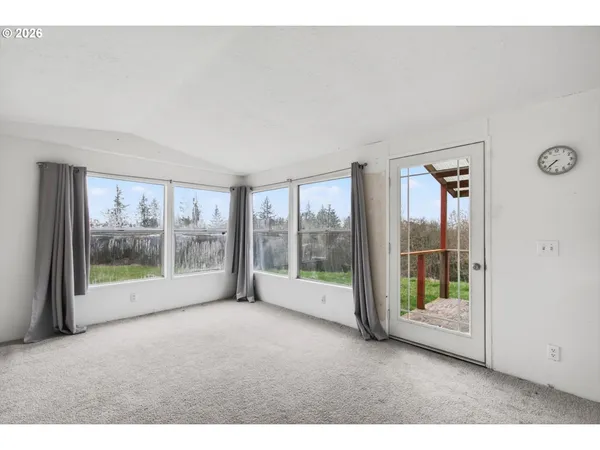 a view of empty room with floor to ceiling window