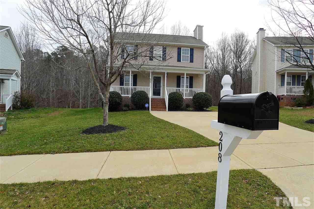 208 Muirfield Ridge Drive Garner, NC 27529 - Photo 2 of 30 a front view of a house with garden