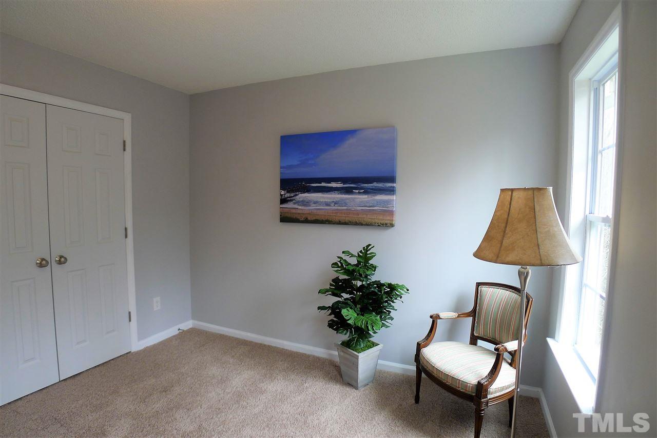 208 Muirfield Ridge Drive Garner, NC 27529 - Photo 17 of 30 a living room with furniture and a lamp