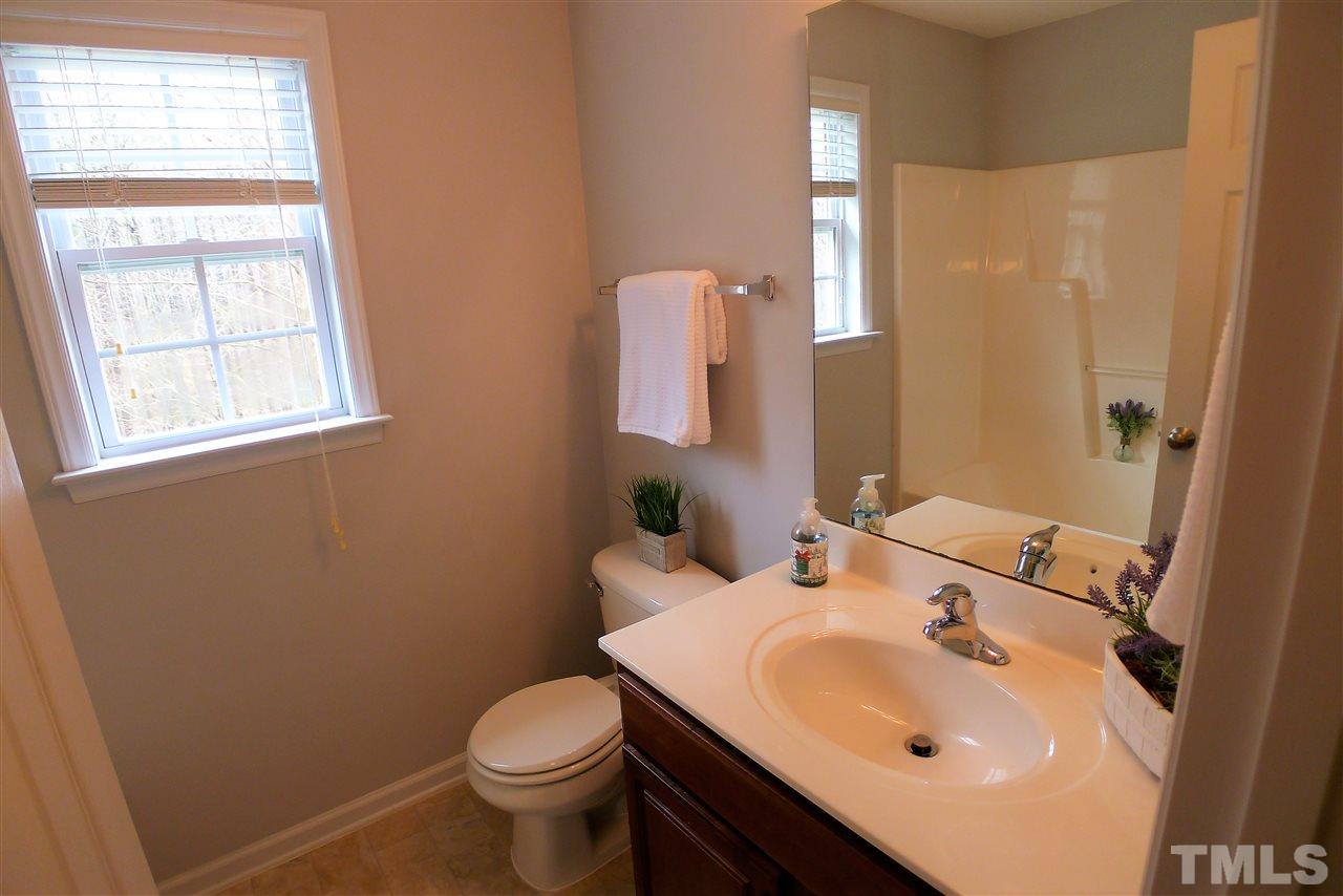 208 Muirfield Ridge Drive Garner, NC 27529 - Photo 19 of 30 a bathroom with a sink toilet and mirror