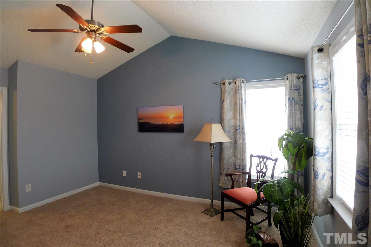 208 Muirfield Ridge Drive Garner, NC 27529 - Photo 21 of 30 a room with furniture and a potted plant