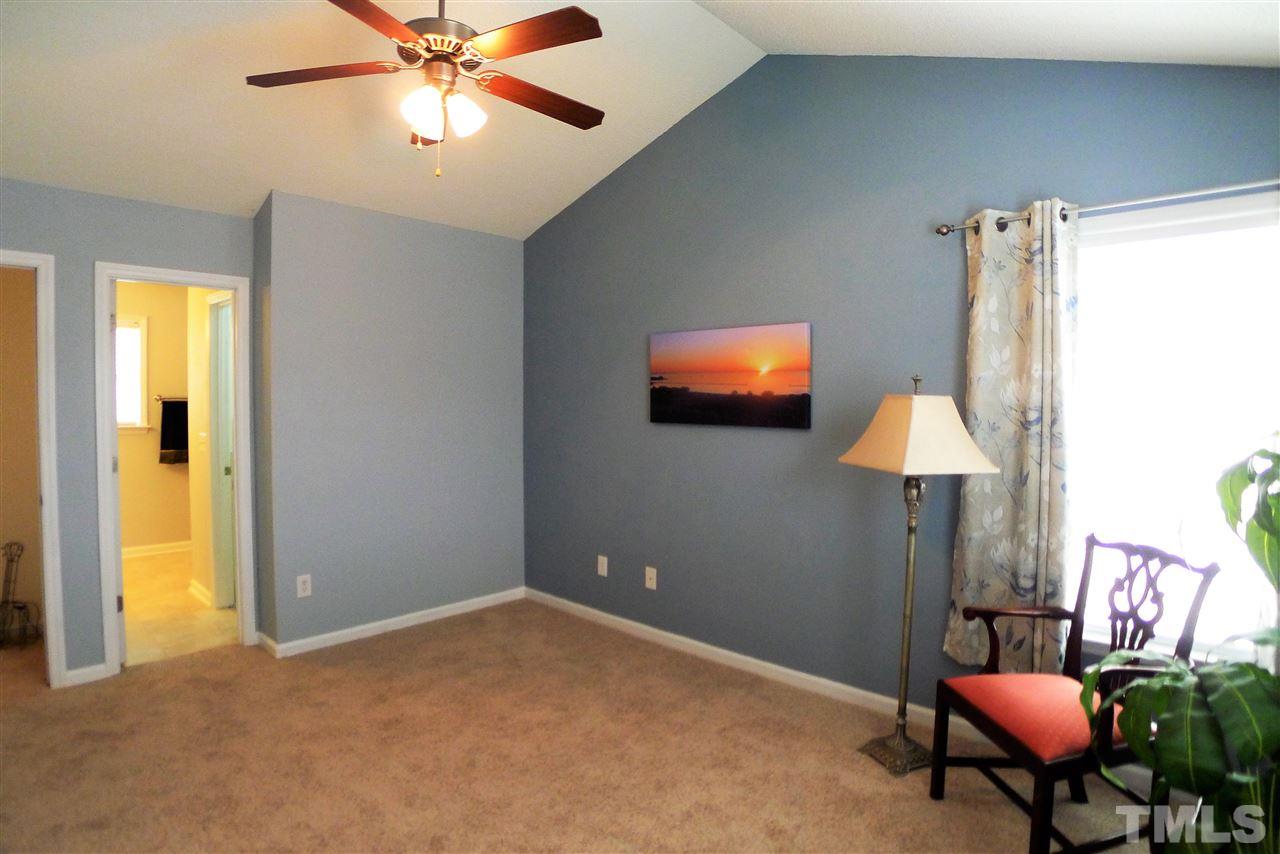 208 Muirfield Ridge Drive Garner, NC 27529 - Photo 22 of 30 a workspace with furniture and chandelier