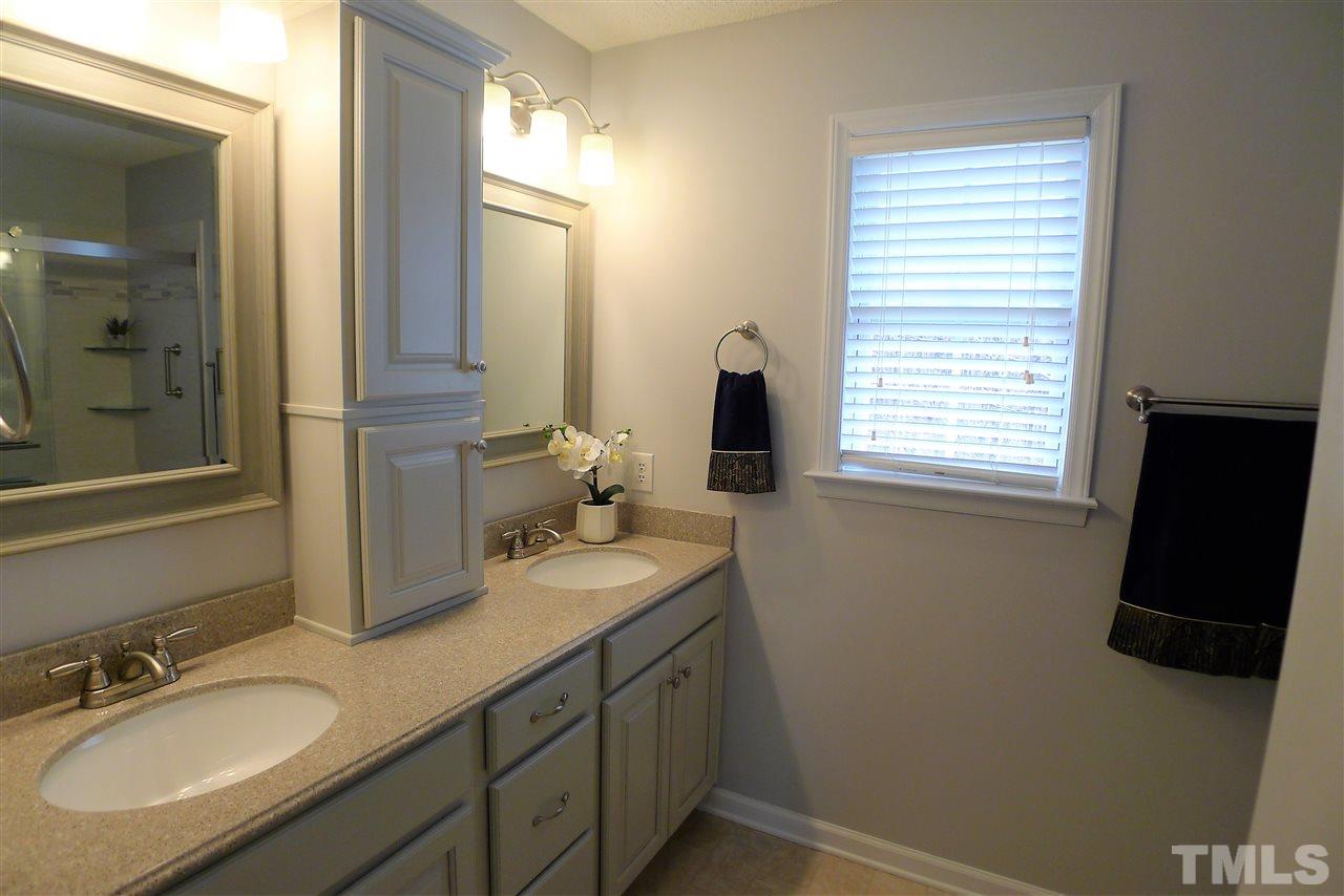 208 Muirfield Ridge Drive Garner, NC 27529 - Photo 24 of 30 a bathroom with a granite countertop sink and a mirror