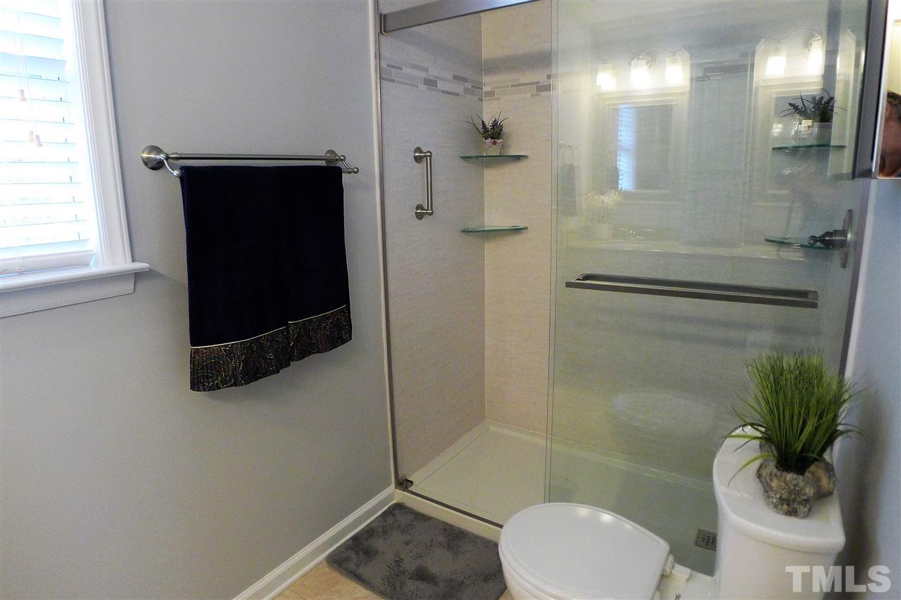 208 Muirfield Ridge Drive Garner, NC 27529 - Photo 25 of 30 a bathroom with a shower and a toilet
