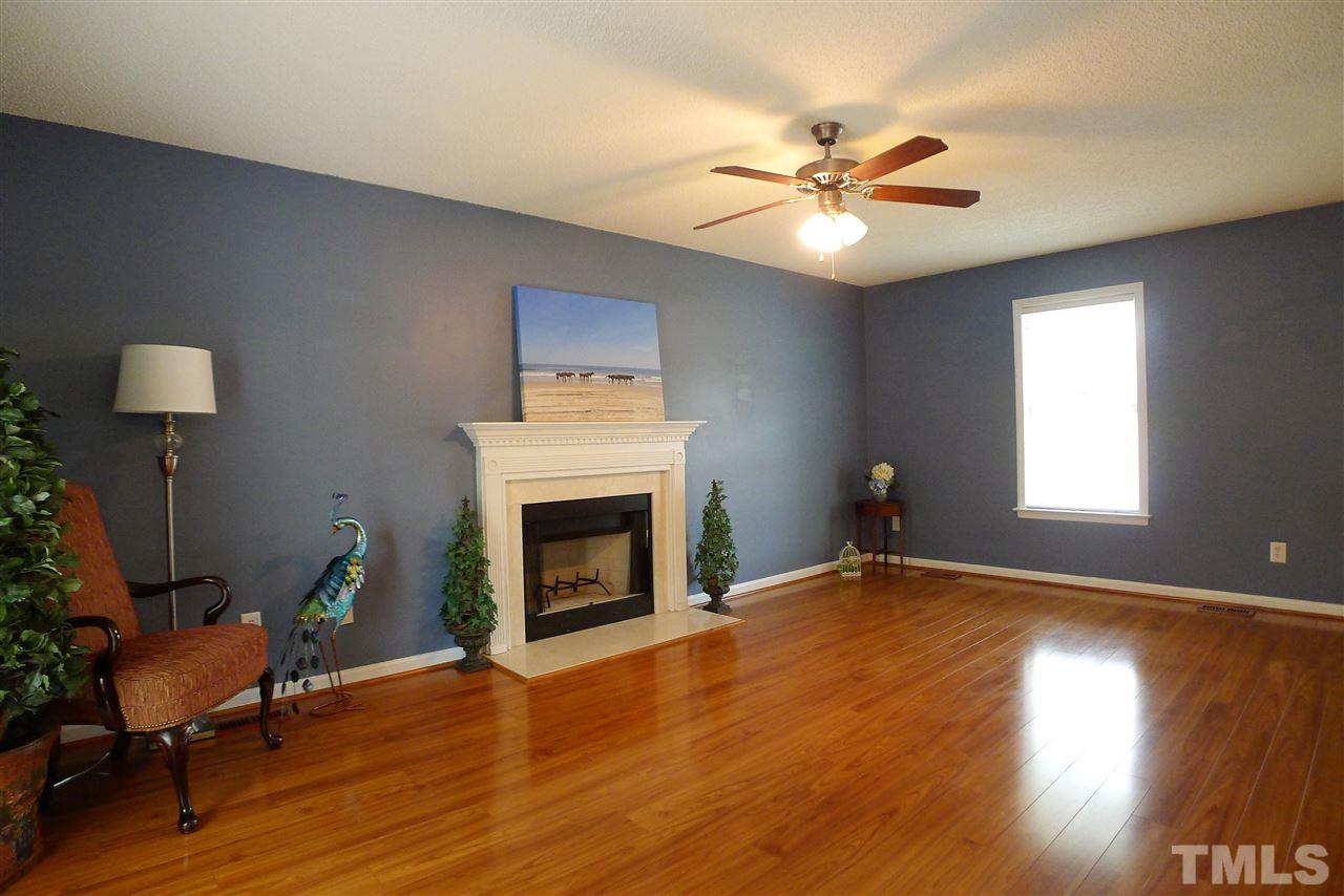 208 Muirfield Ridge Drive Garner, NC 27529 - Photo 4 of 30 a view of a livingroom with furniture and a fireplace