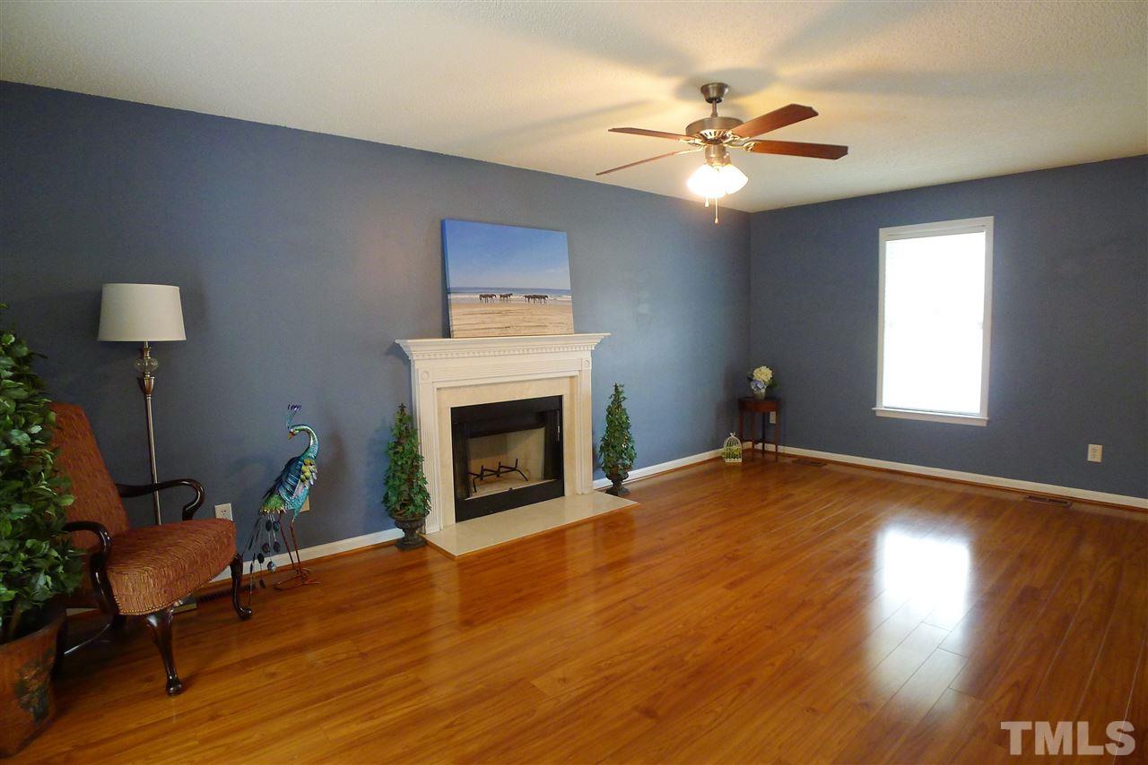 208 Muirfield Ridge Drive Garner, NC 27529 - Photo 6 of 30 a view of a livingroom with furniture and a fireplace