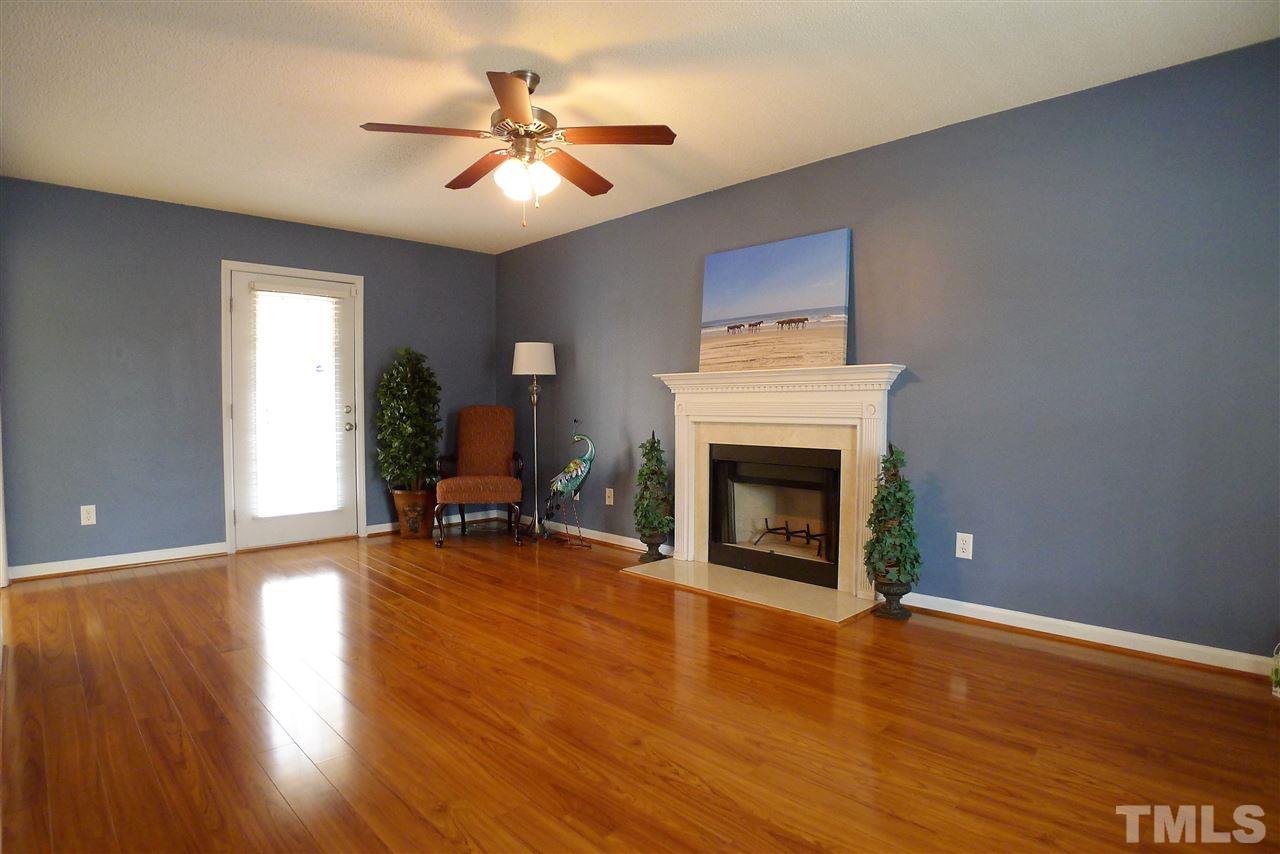 208 Muirfield Ridge Drive Garner, NC 27529 - Photo 7 of 30 a living room with furniture and a fireplace
