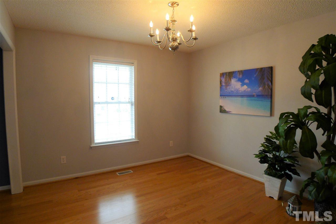 208 Muirfield Ridge Drive Garner, NC 27529 - Photo 8 of 30 a view of empty room with window and flower pot