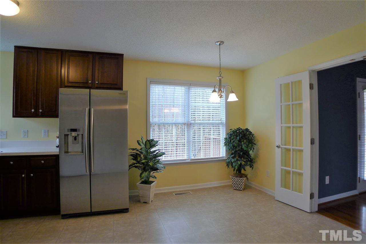 208 Muirfield Ridge Drive Garner, NC 27529 - Photo 10 of 30 a view of a kitchen with a refrigerator and a sink