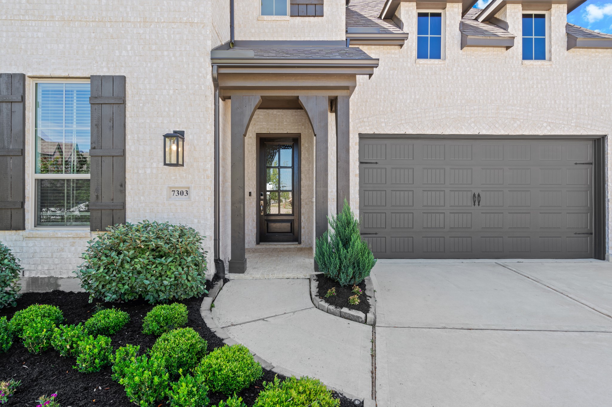 7303 Compass Drive Katy, TX 77493 - Photo 2 of 31 a front view of a house with potted plants