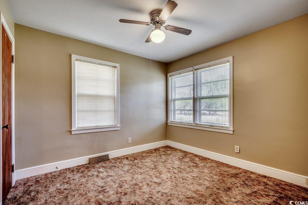4278 Thomas Street Loris, SC 29569 - Photo 13 of 24 Carpeted empty room with ceiling fan