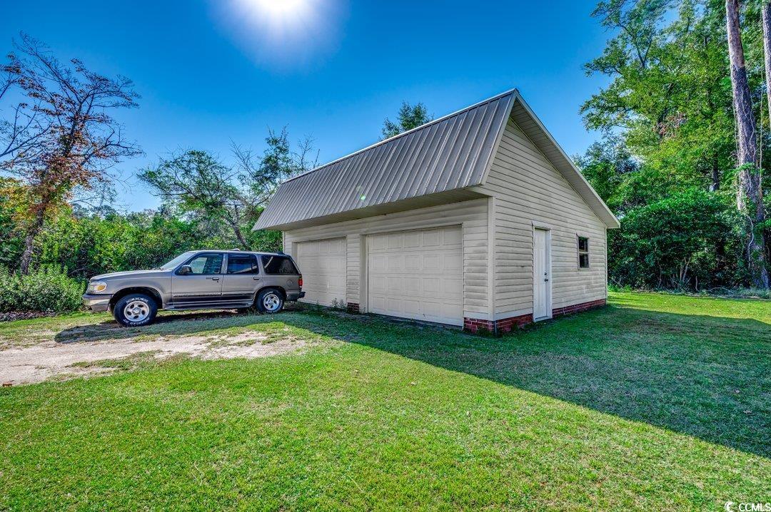 4278 Thomas Street Loris, SC 29569 - Photo 20 of 24 Garage with a yard