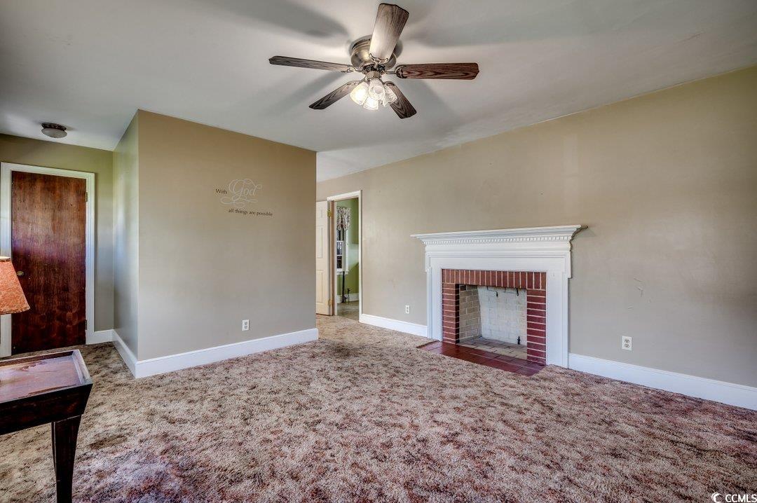 4278 Thomas Street Loris, SC 29569 - Photo 3 of 24 Unfurnished living room with a brick fireplace, ca