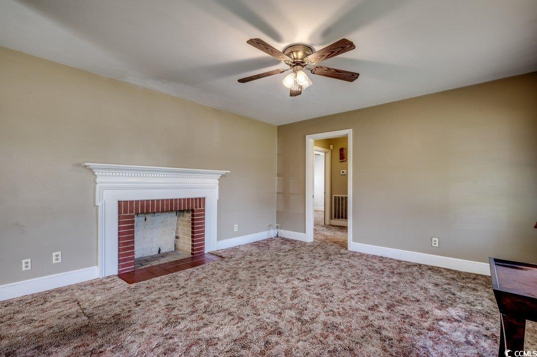 4278 Thomas Street Loris, SC 29569 - Photo 4 of 24 Unfurnished living room with ceiling fan, a firepl