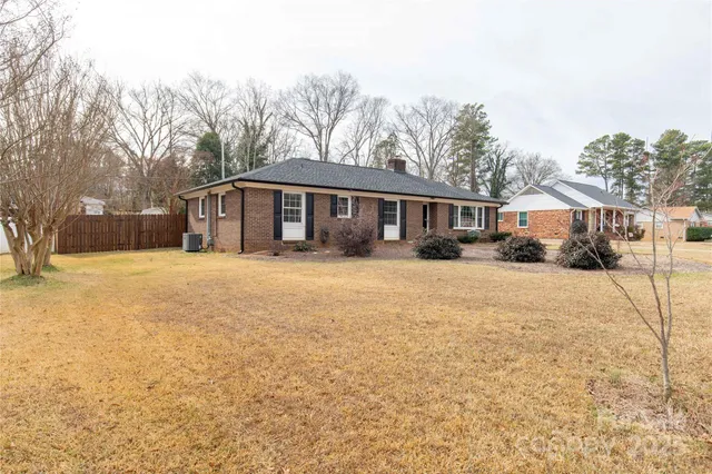 a view of a house with a yard covered in snow