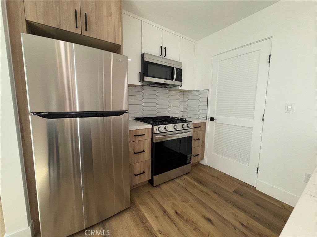 4454 Clinton Street, Unit 1/2 Los Angeles, CA 90004 - Photo 8 of 12 a kitchen with a refrigerator stove and microwave