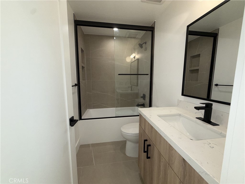 4454 Clinton Street, Unit 1/2 Los Angeles, CA 90004 - Photo 10 of 12 a bathroom with a sink a toilet and shower