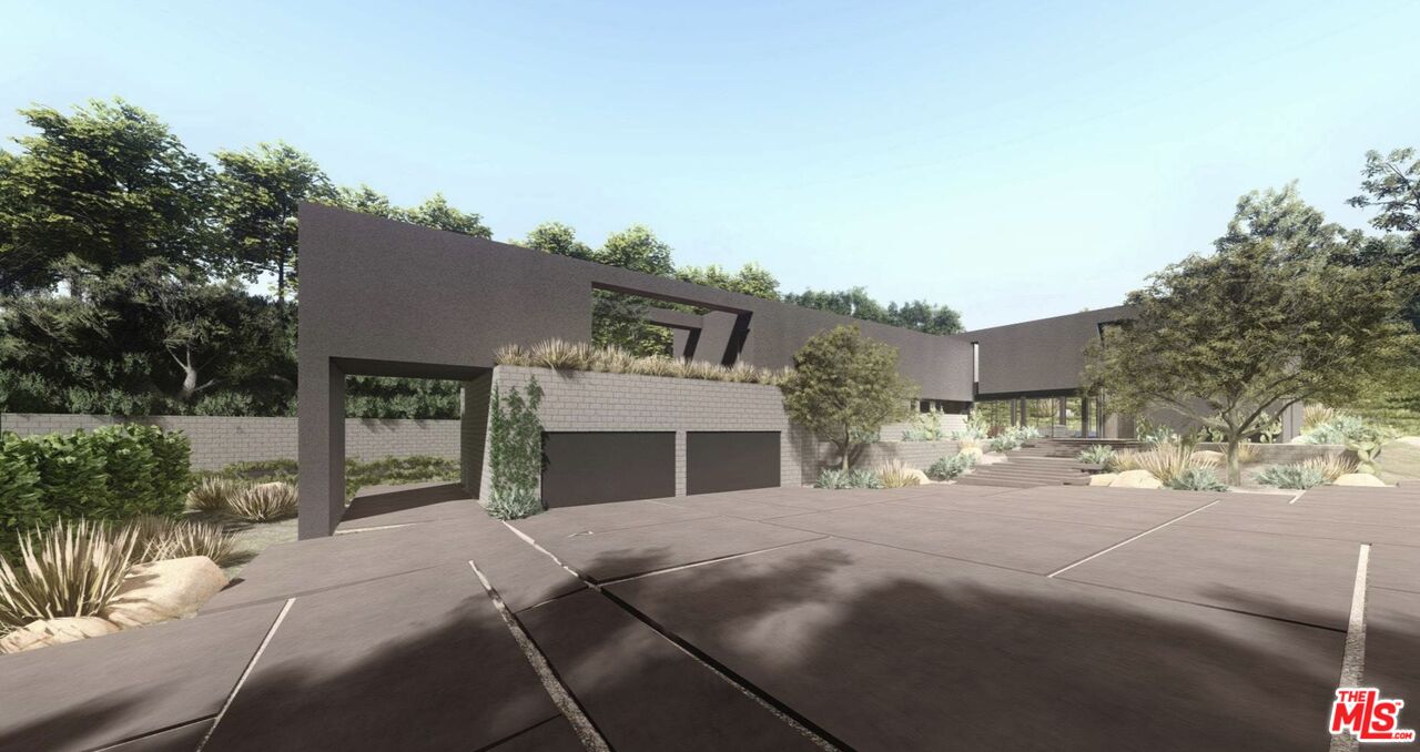 3375 Mandeville Canyon Road Los Angeles, CA 90049 - Photo 8 of 13 a front view of a house with a yard