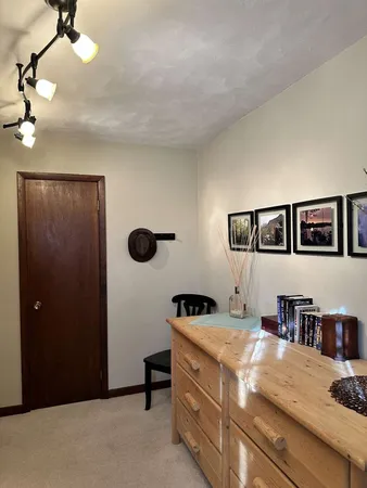 a bedroom with a bed and a book shelf