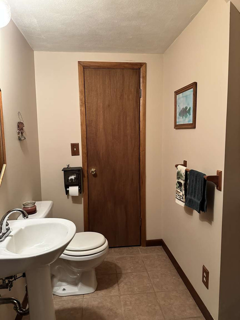 11 Marty Lane Macomb, IL 61455 - Photo 18 of 25 a bathroom with a sink a toilet and shower