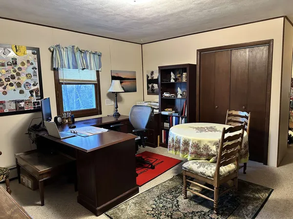 a room with furniture a rug and a window