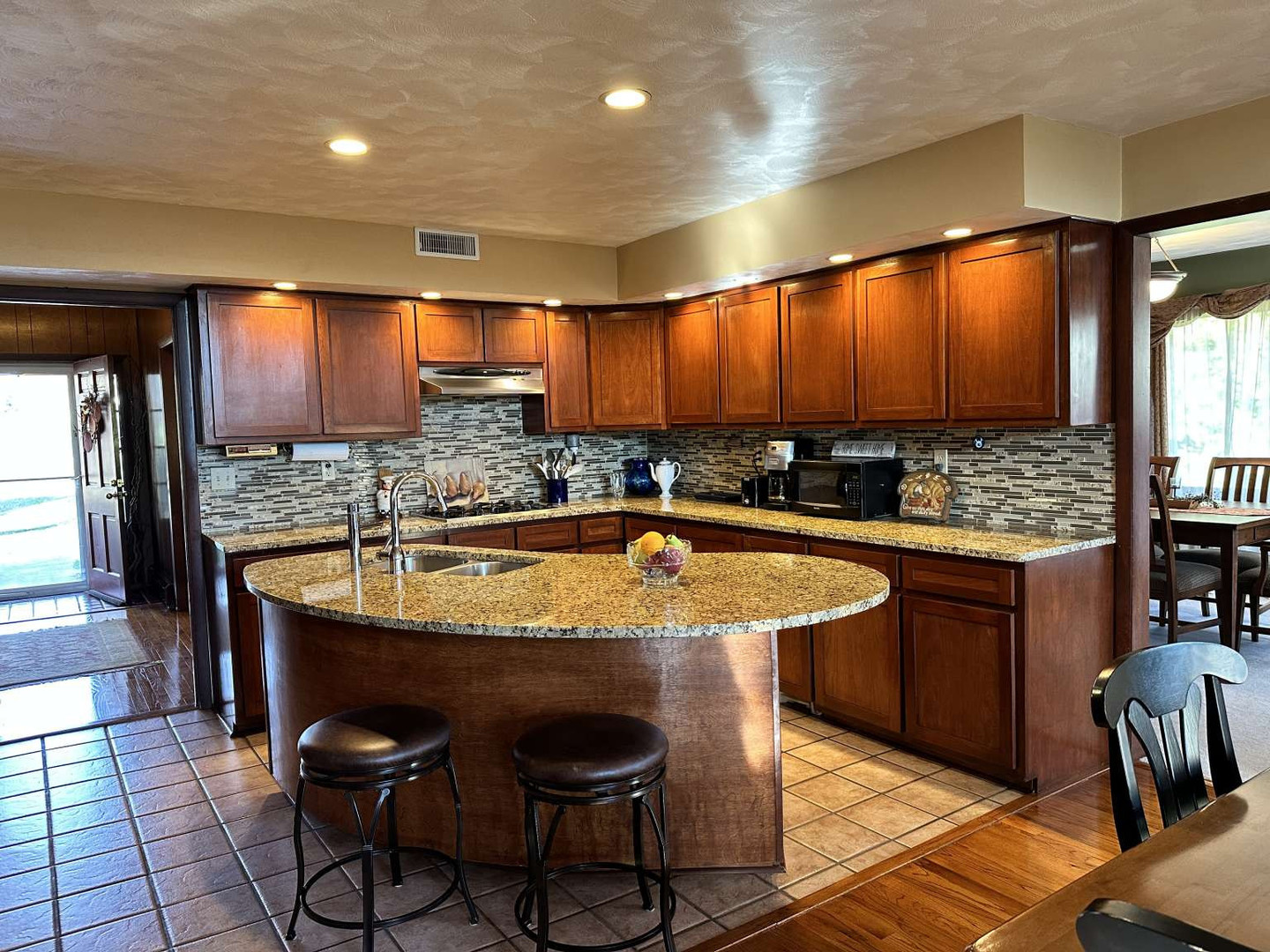 11 Marty Lane Macomb, IL 61455 - Photo 5 of 25 a kitchen with stainless steel appliances granite countertop wooden cabinets a sink and a stove