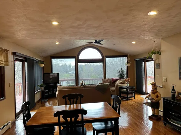 a view of a dining room with furniture window and wooden floor