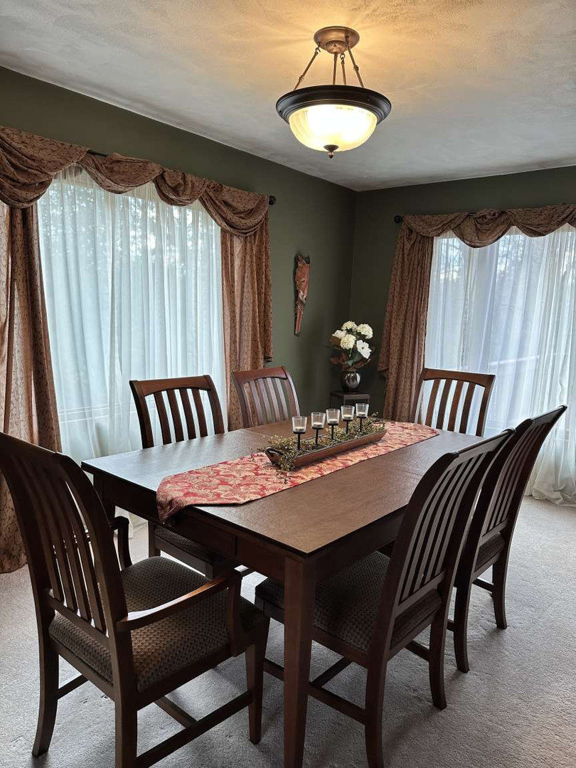 11 Marty Lane Macomb, IL 61455 - Photo 8 of 25 a view of a dining room with furniture and chandelier
