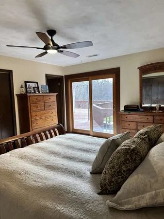 a bedroom with a bed and a large window