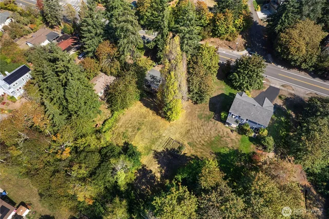 an aerial view of residential house with yard and outdoor seating