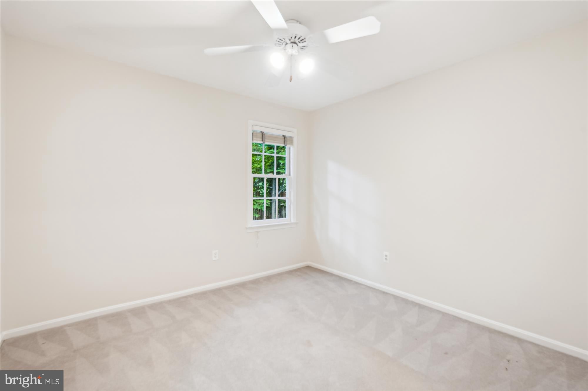 8200 Bells Mill Road Potomac, MD 20854 - Photo 44 of 67 an empty room with a window and a ceiling fan