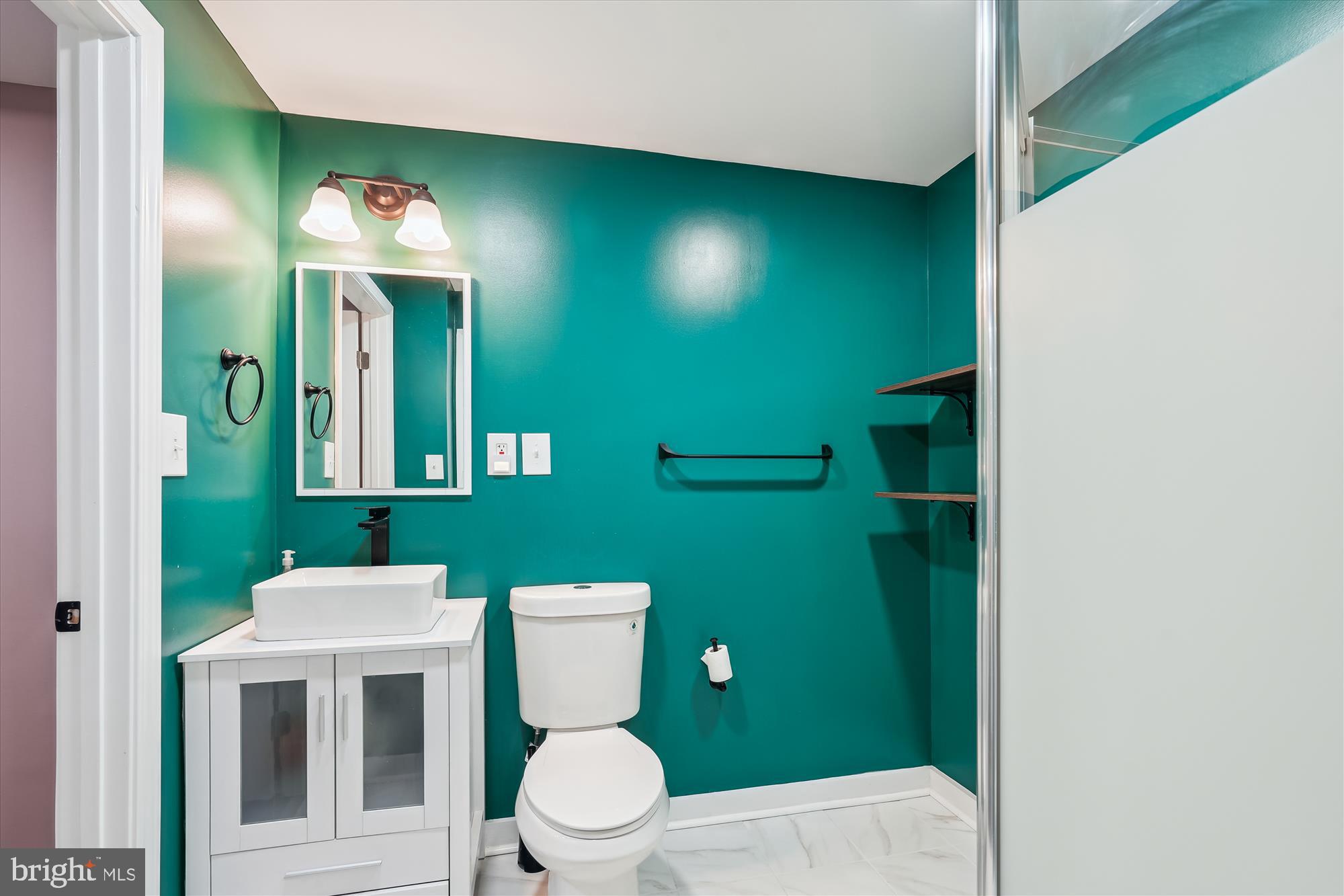 8200 Bells Mill Road Potomac, MD 20854 - Photo 54 of 67 a bathroom with a toilet sink and mirror