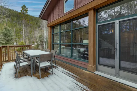 a balcony with table and chairs