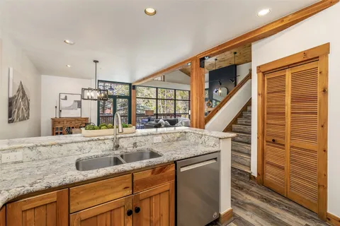 a view of a kitchen with a sink and wooden floors