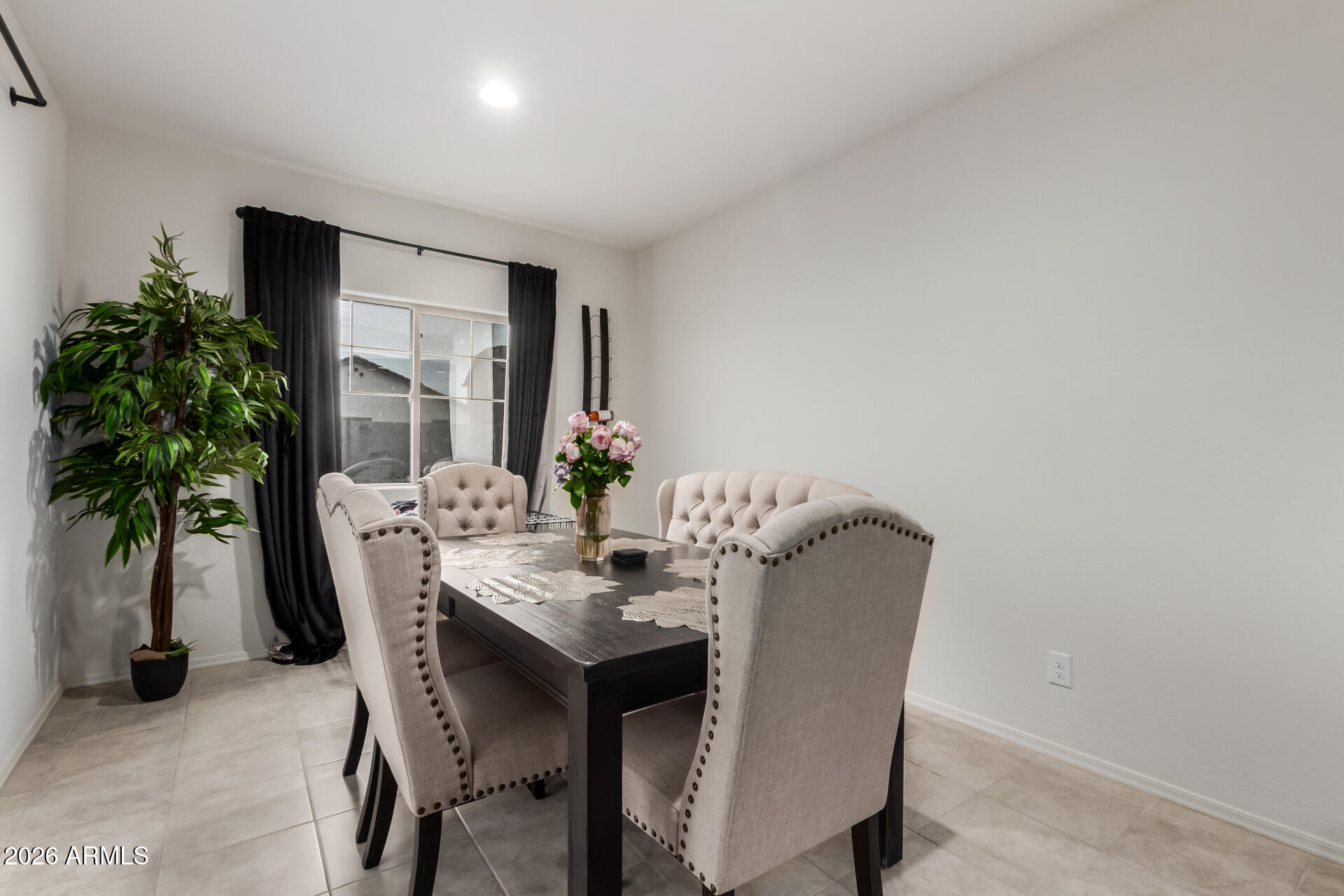 11214 West Bloch Road Tolleson, AZ 85353 - Photo 12 of 24 a dining room with furniture and a potted plant