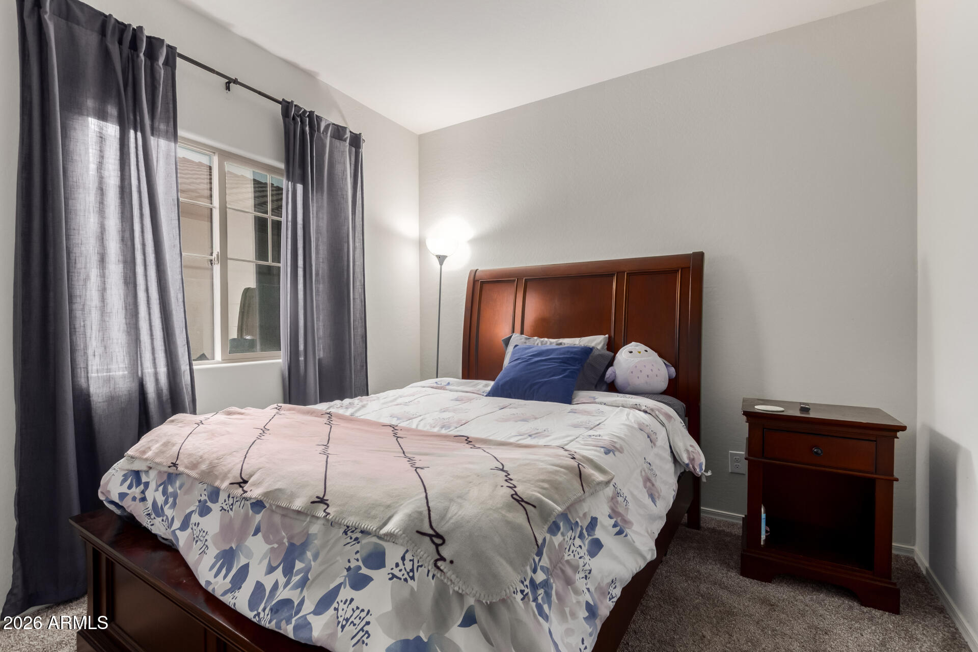 11214 West Bloch Road Tolleson, AZ 85353 - Photo 17 of 24 a large bed sitting in a bedroom next to a window and a larger closet
